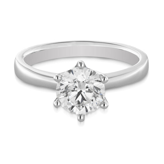 The Raffi&Co.® 18K White Gold Round Brilliant Solitaire Diamond Engagement Ring showcases a stunning round brilliant diamond in a six-prong setting, beautifully crafted from 18K white gold and elegantly presented against a plain white background.