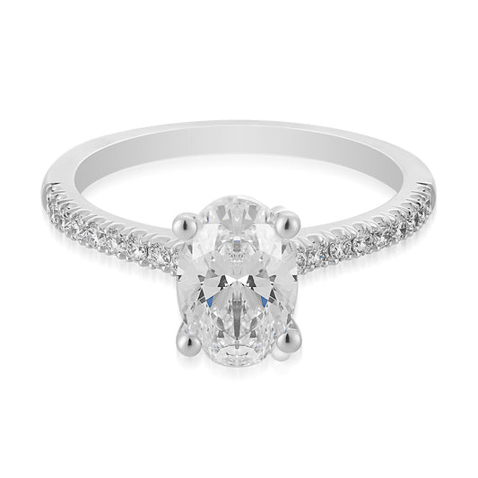 The Raffi&Co.® 14K White Gold Oval Solitaire Diamond Engagement Ring is a breathtaking piece, featuring an oval solitaire diamond at its center and adorned with smaller diamonds along the band, all set against a pristine white background.