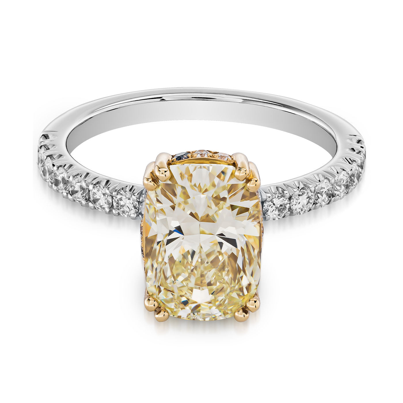 Introducing the Raffi&Co.® 14K Yellow and White Gold Cushion Hidden Halo Diamond Engagement Ring, a stunning cushion-cut yellow diamond engagement ring in an elegant gold prong setting. The band is crafted from both 14K yellow and white gold, adorned with delicate white diamonds, and accented by a cushion hidden halo for enhanced brilliance.