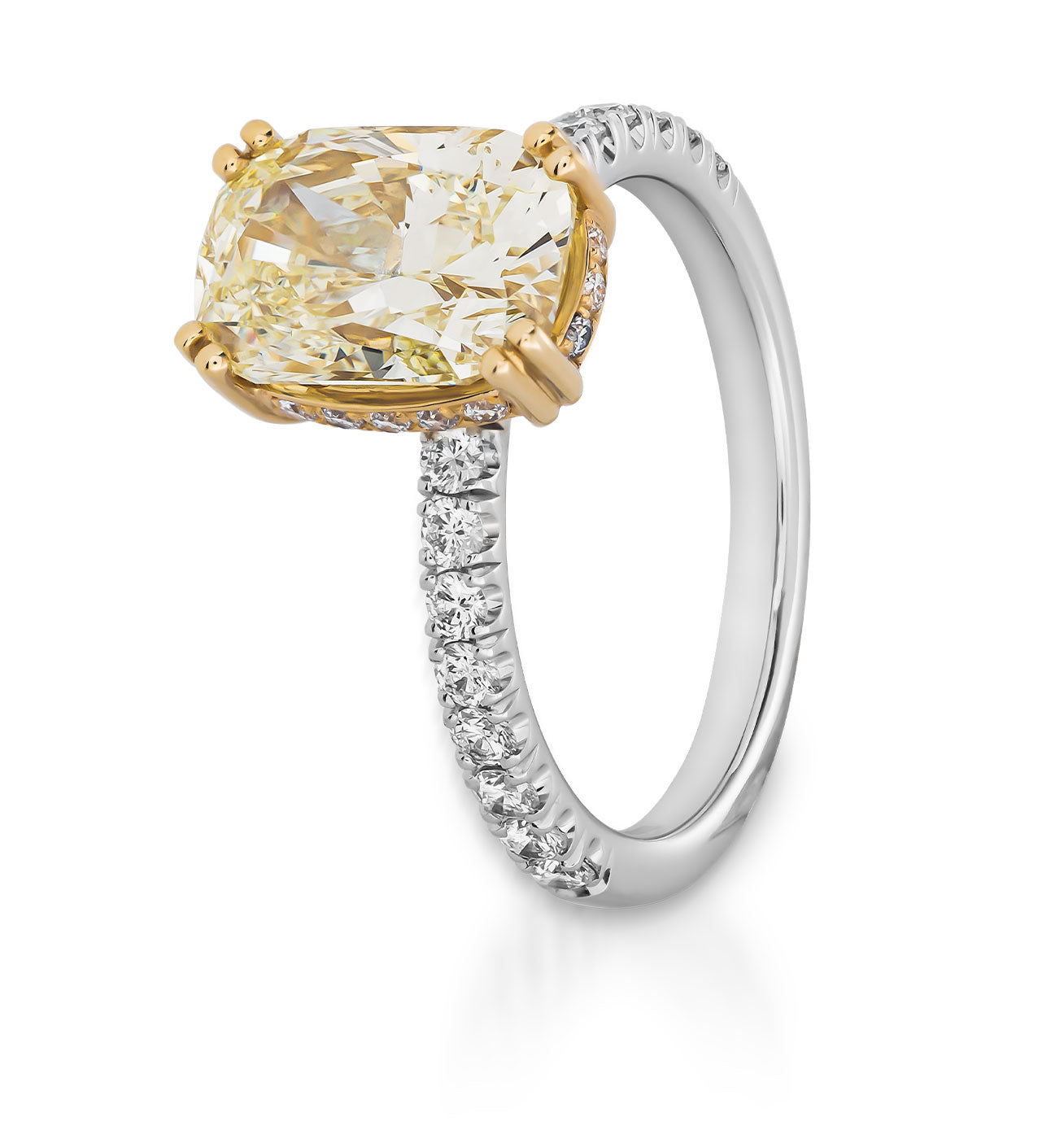 The Raffi&Co.® 14K Yellow and White Gold Cushion Hidden Halo Diamond Engagement Ring features a captivating design with an oval-shaped yellow diamond set in yellow gold prongs. The elegant band is a blend of 14K yellow and white gold, embellished with small round diamonds for extra sparkle, while the cushion hidden halo adds an additional touch of brilliance.