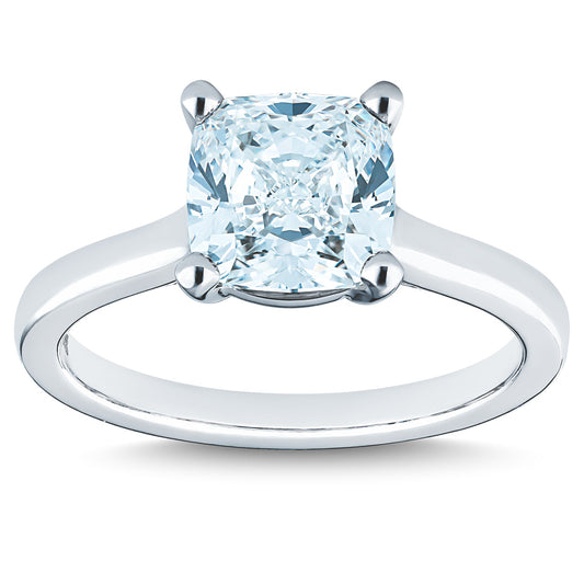 The Raffi&Co.® 14K White Gold Cushion Diamond Solitaire Engagement Ring showcases a prominent cushion-cut diamond secured with four prongs on a sleek and polished band, emphasizing the diamond's brilliance.