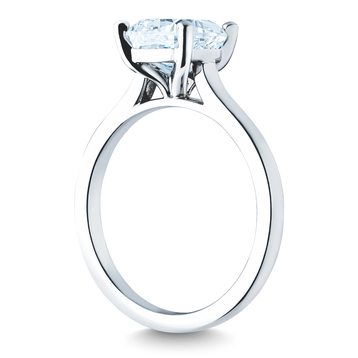 A close-up image of the Raffi&Co.® 14K White Gold Cushion Diamond Solitaire Engagement Ring, showcasing its sparkling diamond in a prong setting. The smooth and shiny band contributes to its elegant and classic appearance against a plain white background.