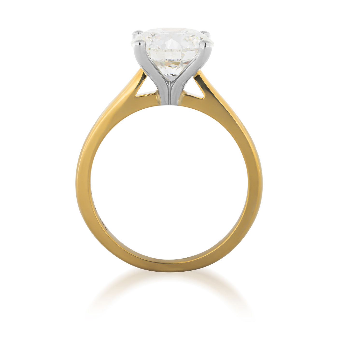 The Raffi&Co® 18K Yellow Gold Round Brilliant Solitaire Diamond Engagement Ring features a stunning round brilliant diamond in a white gold prong setting. Photographed upright, the elegant band design is highlighted, while the simplicity and brilliance of the gemstone take center stage, beautifully complemented by 18K yellow gold accents.