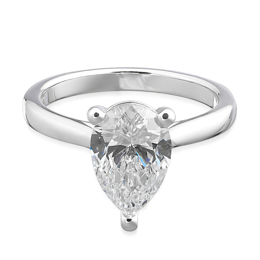 The Raffi&Co.® 14K White Gold Pear Solitaire Diamond Engagement Ring features a breathtaking pear solitaire diamond at its center, held securely by three prongs. Its sleek and polished band beautifully enhances the brilliance of the gemstone.