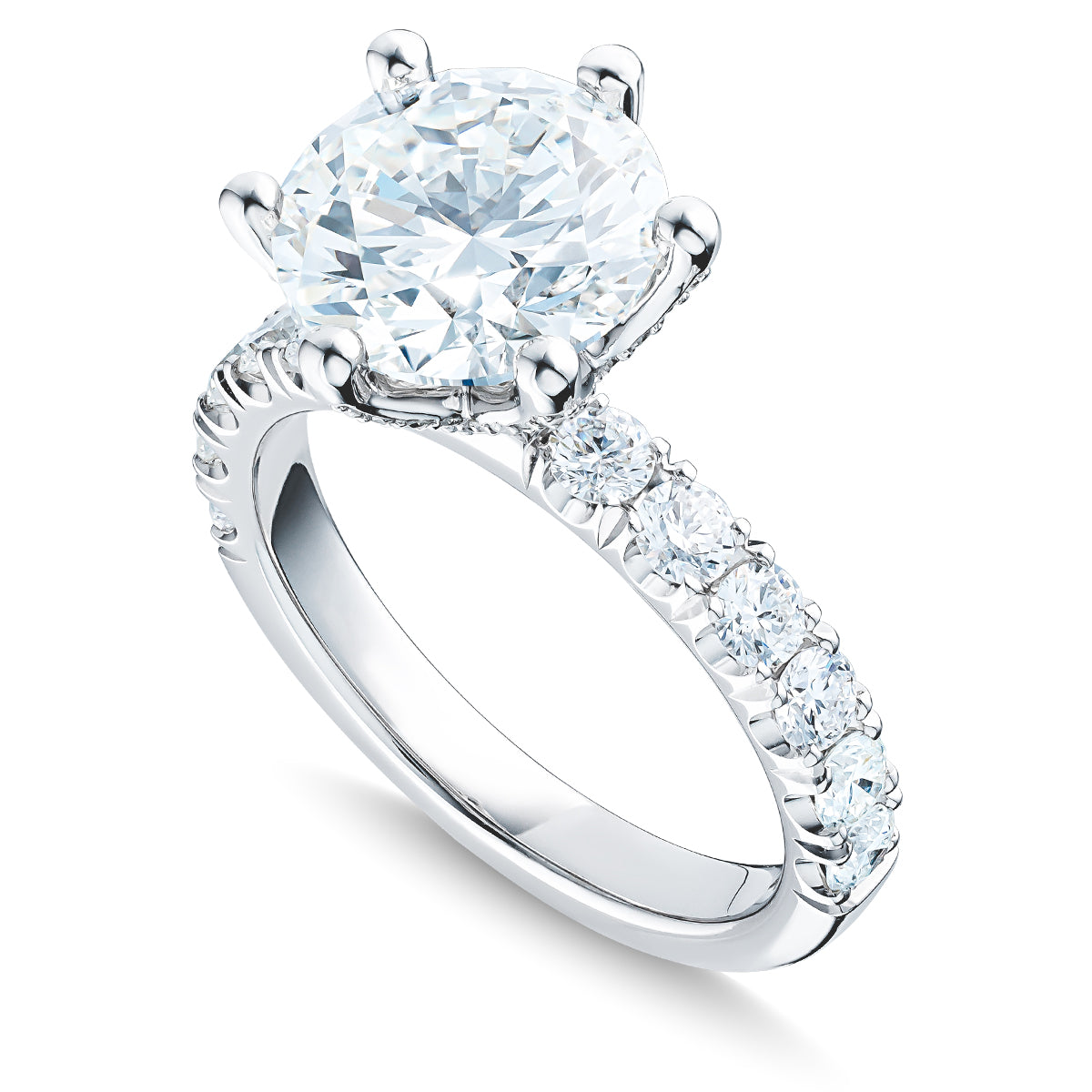 Introducing the Raffi&Co.® 14K White Gold Round Brilliant Diamond Halo Engagement Ring, featuring a stunning large round diamond centerpiece. The band is adorned with smaller diamonds set along the top half, enhancing its sparkle and elegance. This exquisite piece is beautifully showcased against a white background.