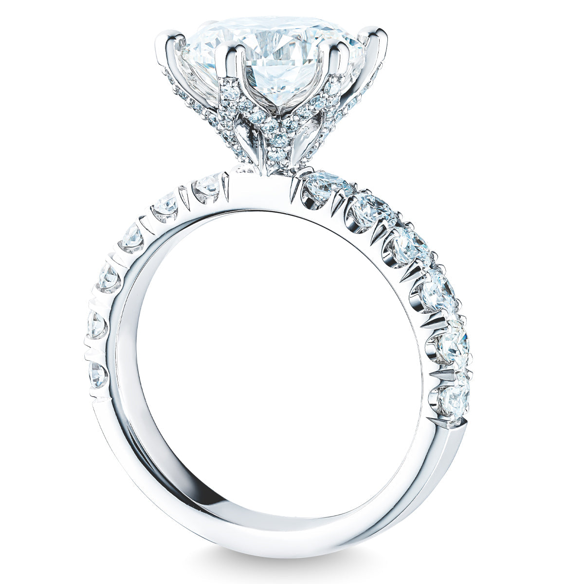 Introducing the Raffi&Co.® 14K White Gold Round Brilliant Diamond Halo Engagement Ring, featuring a stunning large round diamond centerpiece surrounded by a halo of smaller diamonds along the band. Its intricate setting enhances its elegance and sparkle.