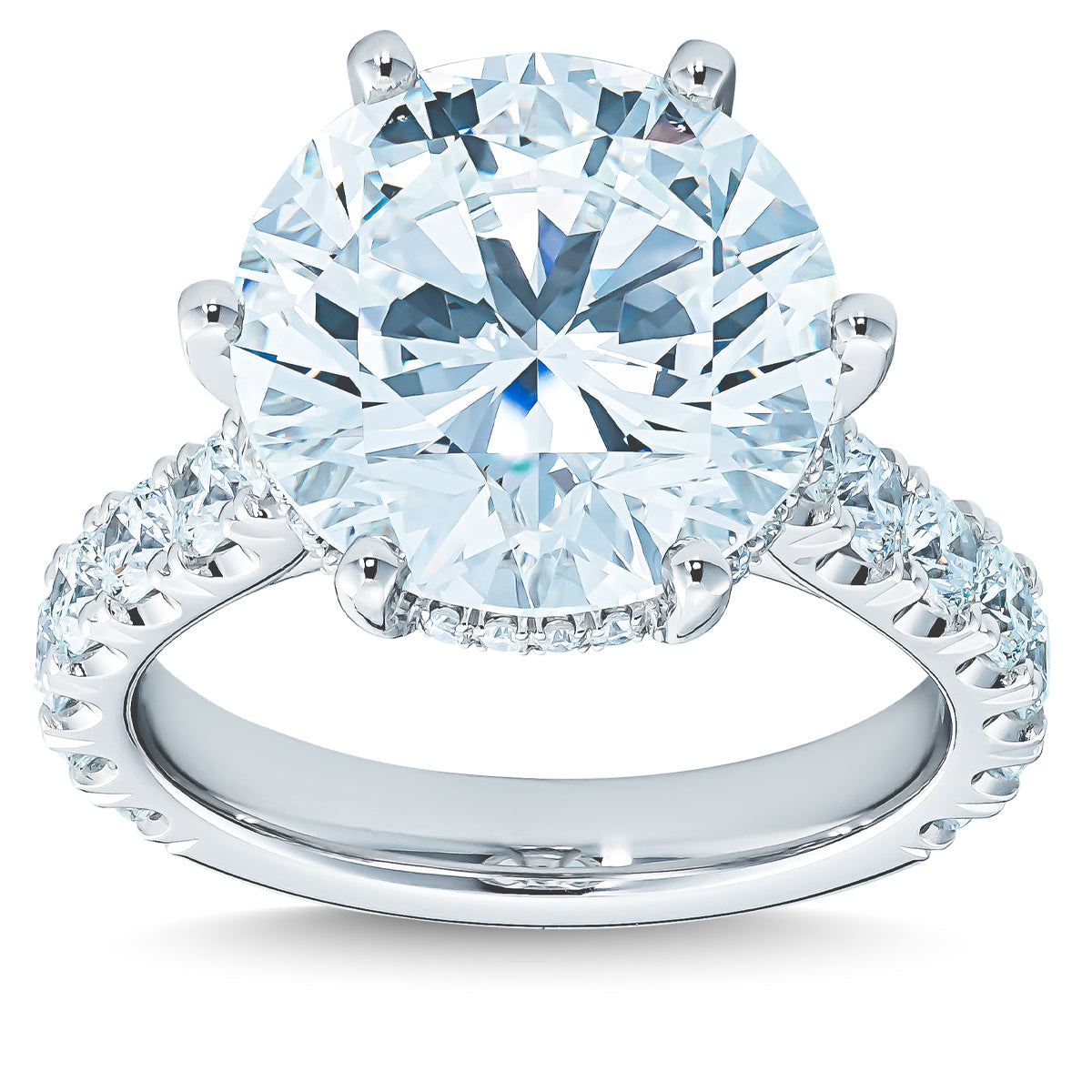 A magnificent Raffi&Co.® 18K White Gold Round Brilliant Hidden Halo Diamond Engagement Ring, featuring a round-cut diamond centerpiece and smaller diamonds artfully set along the band, is elegantly showcased against a white background to highlight its brilliance and intricate design.