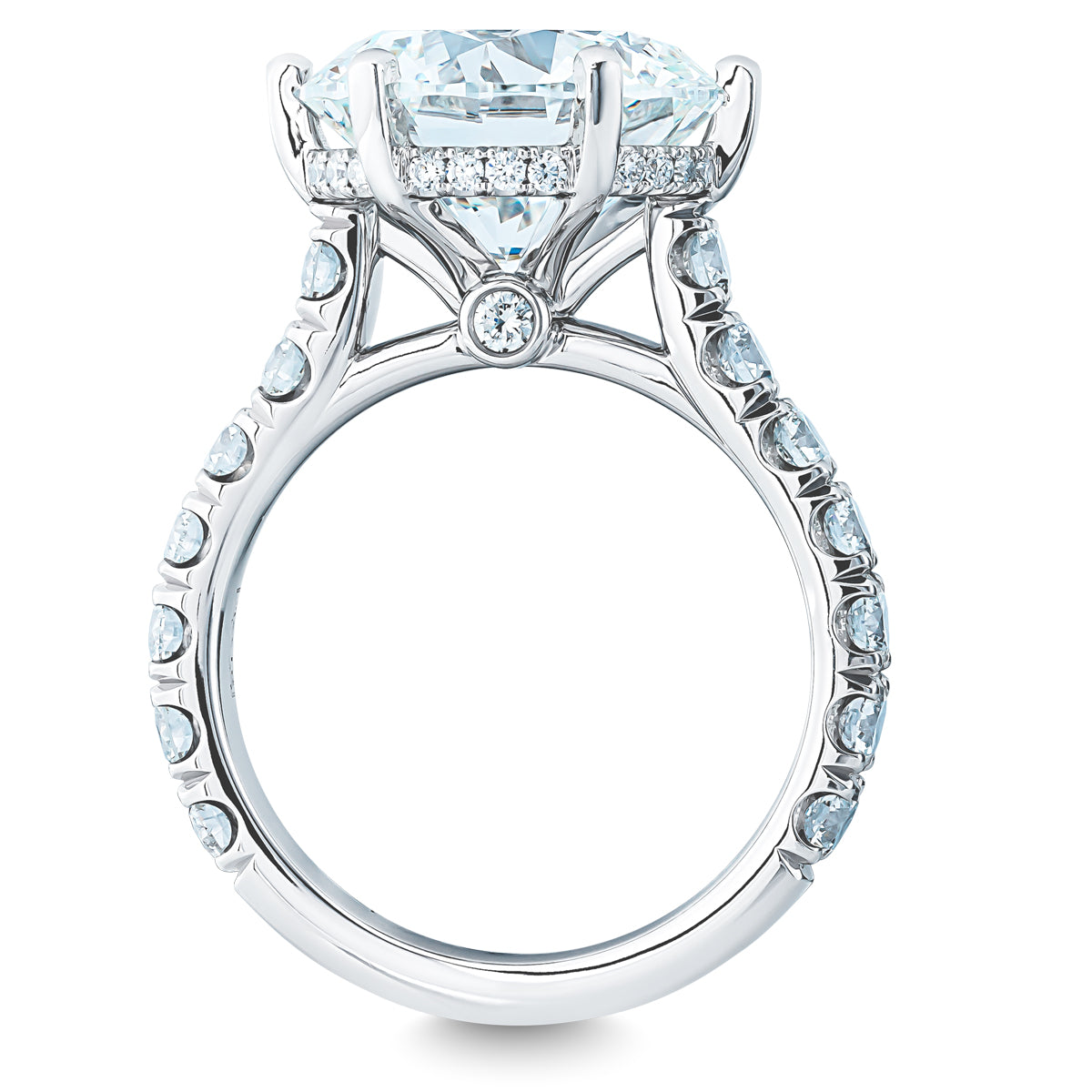 The Raffi&Co.® 18K White Gold Round Brilliant Hidden Halo Diamond Engagement Ring is a stunning engagement ring featuring a large diamond centerpiece, elegantly designed with smaller diamonds encircling the main stone and adorning the band.