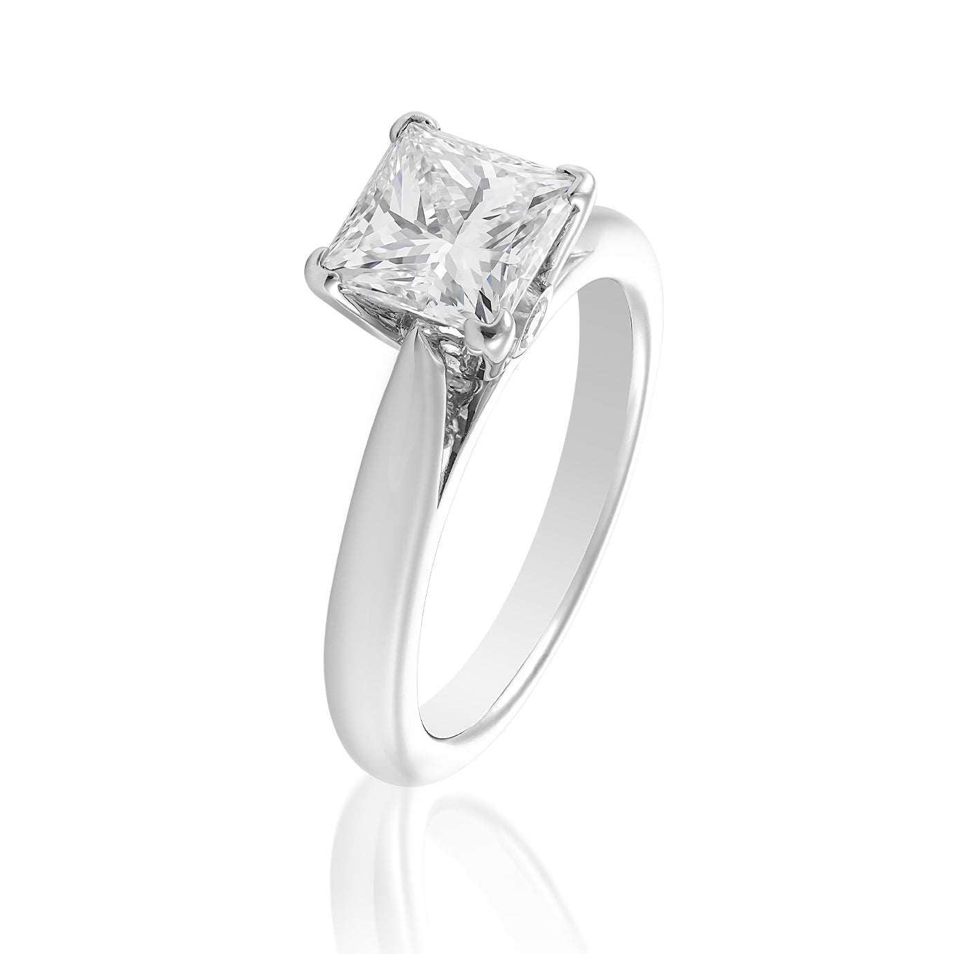 Introducing the Raffi&Co.® 14K White Gold Princess Cut Solitaire Diamond Engagement Ring: A stunning engagement ring featuring a princess cut diamond expertly set in a four-prong setting. Displayed against a white background, its polished 14K white gold band elegantly tapers towards the setting, beautifully enhancing the diamond's brilliance.