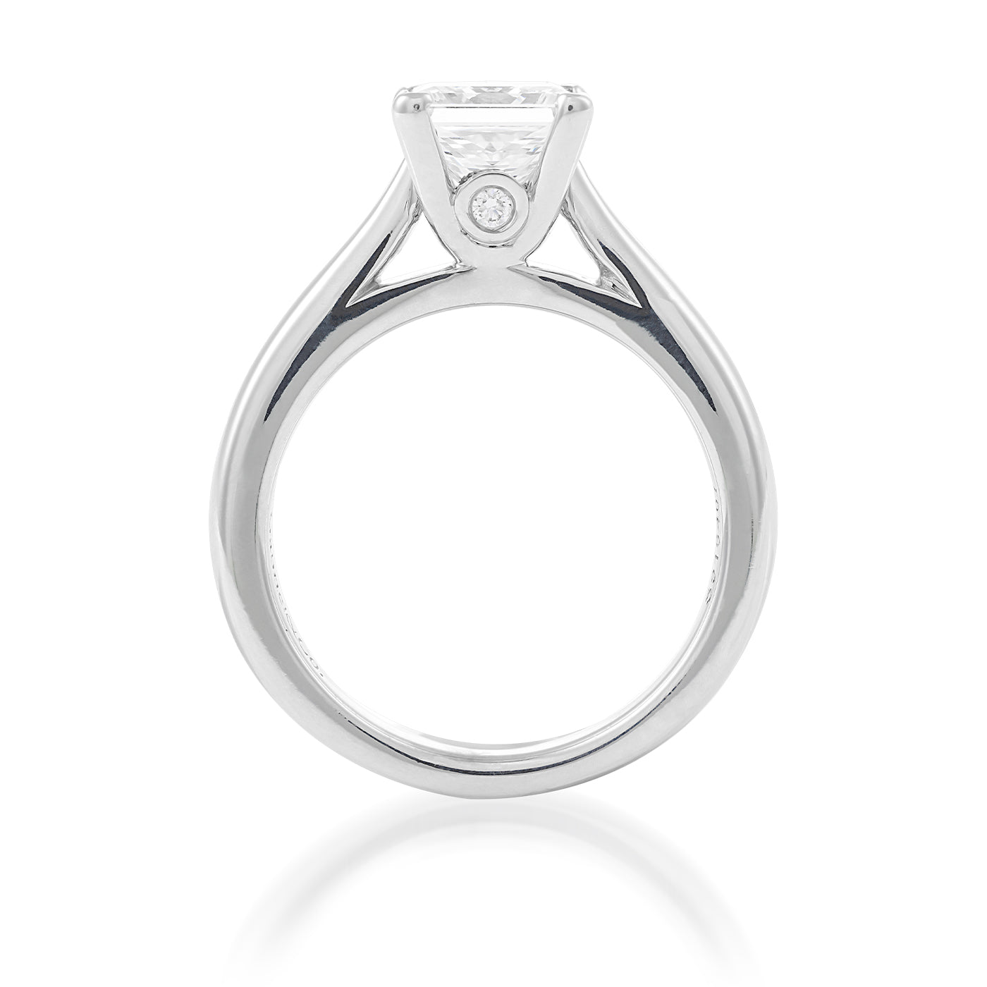 The Raffi&Co.® 14K White Gold Princess Cut Solitaire Diamond Engagement Ring showcases a minimalist design with its slim band and elevated diamond, elegantly displayed against a plain white background.