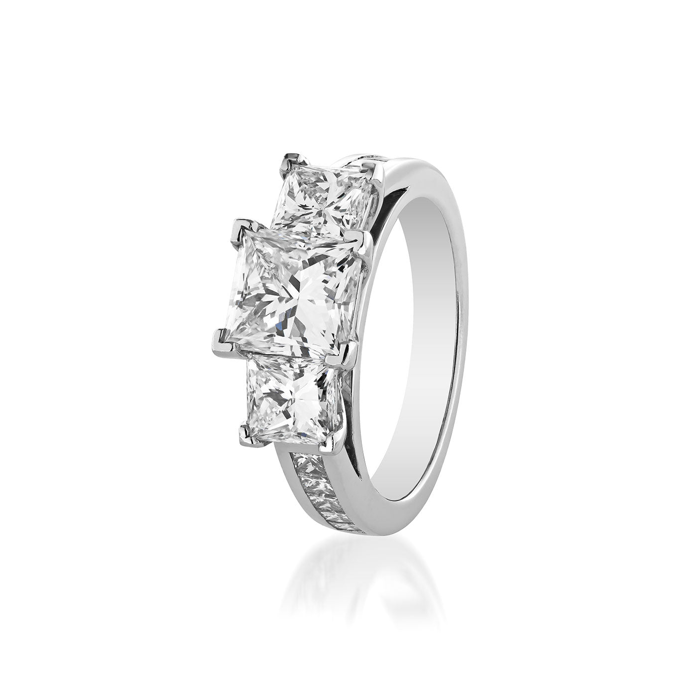 The Raffi&Co.® 14K White Gold Princess Cut Three Stone Diamond Engagement Ring is a sophisticated piece that boasts three prominent princess cut diamonds on the band, complemented by smaller stones elegantly set along the sides. This elegant design is meticulously crafted in exquisite 14K white gold.