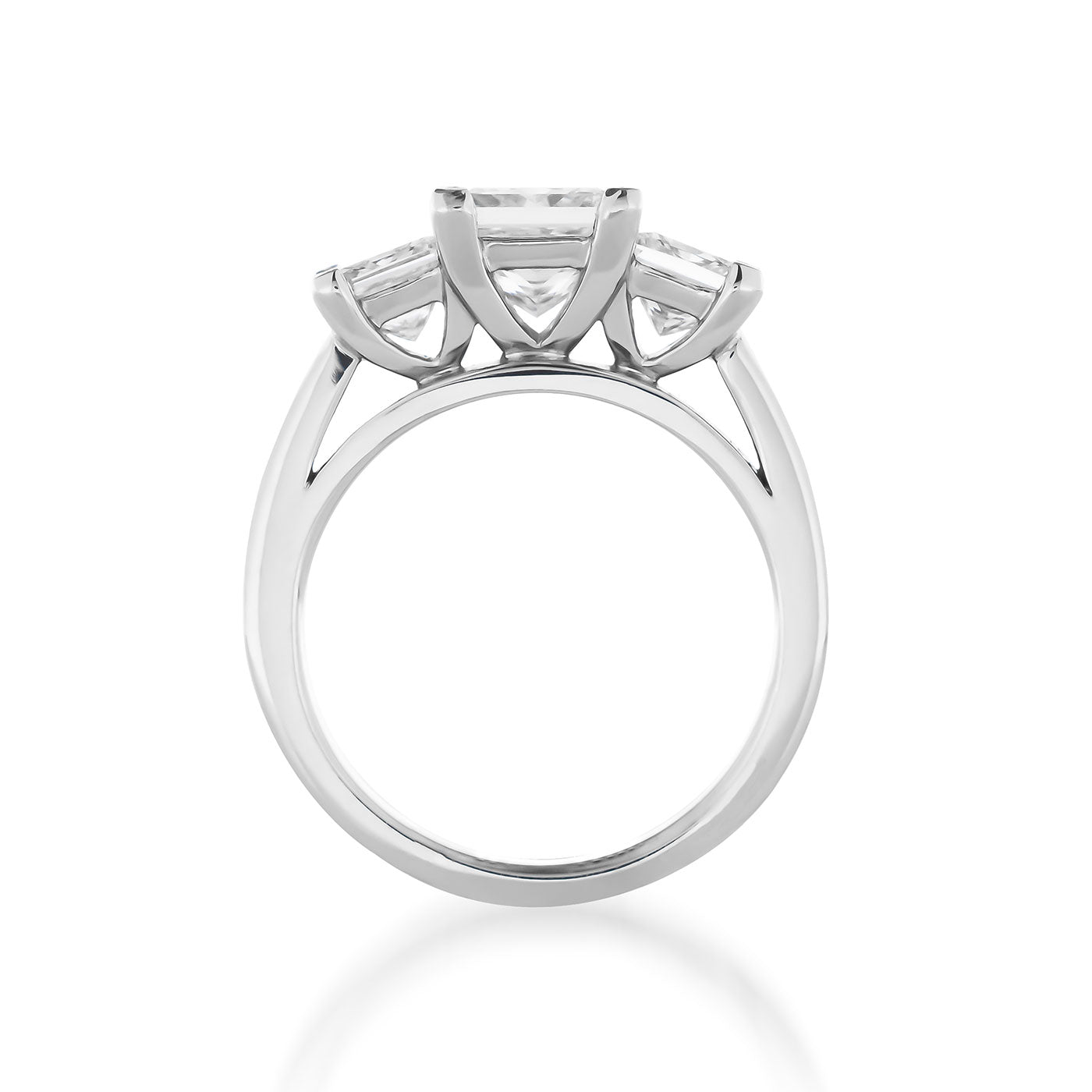 The Raffi&Co.® 14K White Gold Princess Cut Three Stone Diamond Engagement Ring showcases a side view with three prominent, clear princess cut diamonds aligned in a row. The sleek band made of 14K white gold elegantly supports the raised stones, creating a modern design against a white background.