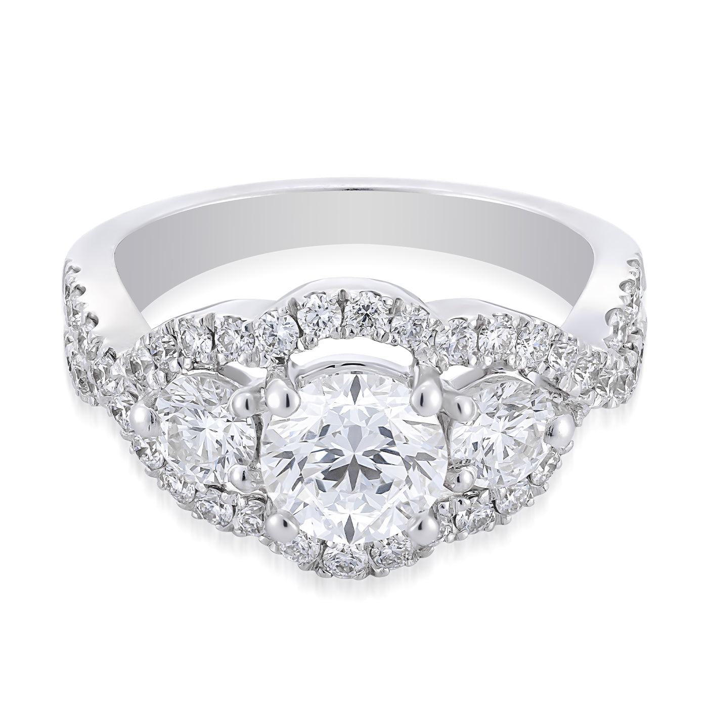 The Raffi&Co.® 14K White Gold Round Brilliant Three Stone Halo Diamond Engagement Ring showcases a round brilliant diamond centerpiece complemented by two smaller round diamonds. The band features a luxurious three-stone halo of smaller diamonds, offering an exquisite display.