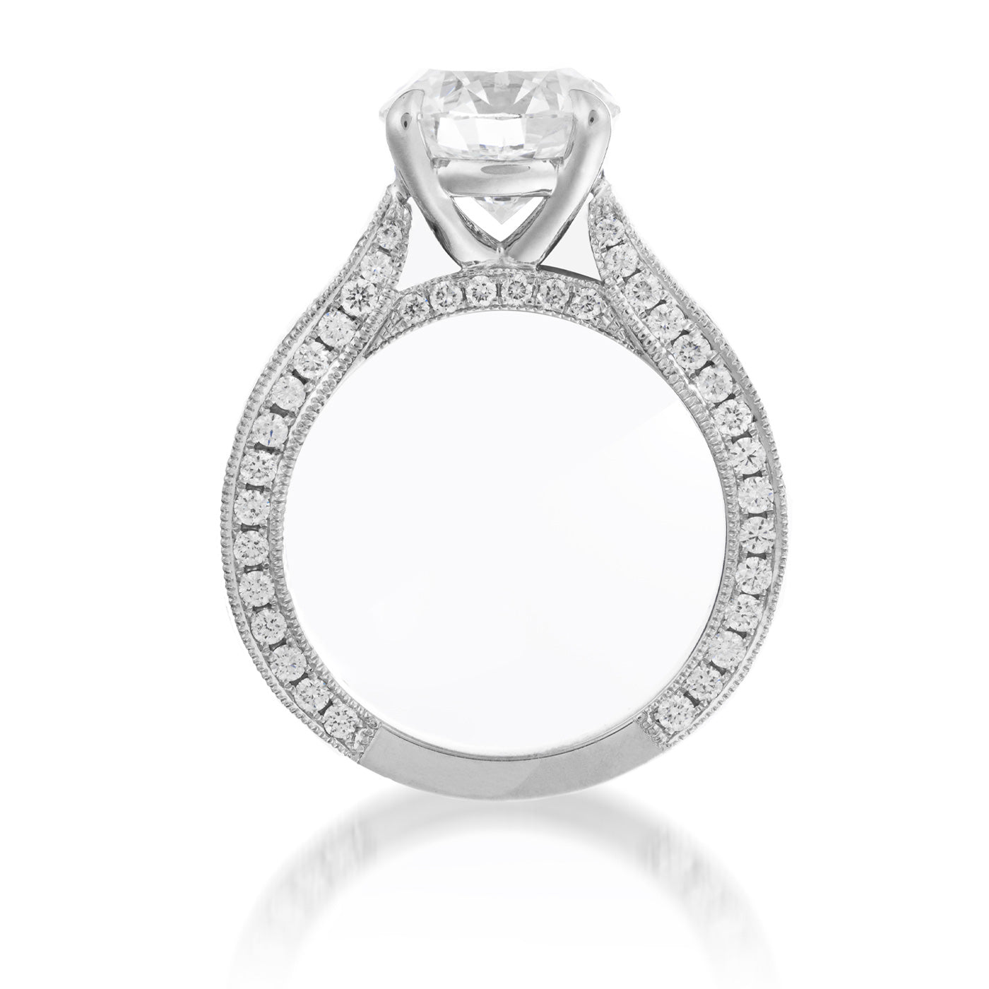 The Raffi&Co.® 18K White Gold Round Brilliant Solitaire Diamond Engagement Ring is showcased up close, displaying a large, round solitaire diamond at its center. The elegantly crafted band is adorned with smaller diamonds along its sides for a stunning sparkle, set against a plain white background.