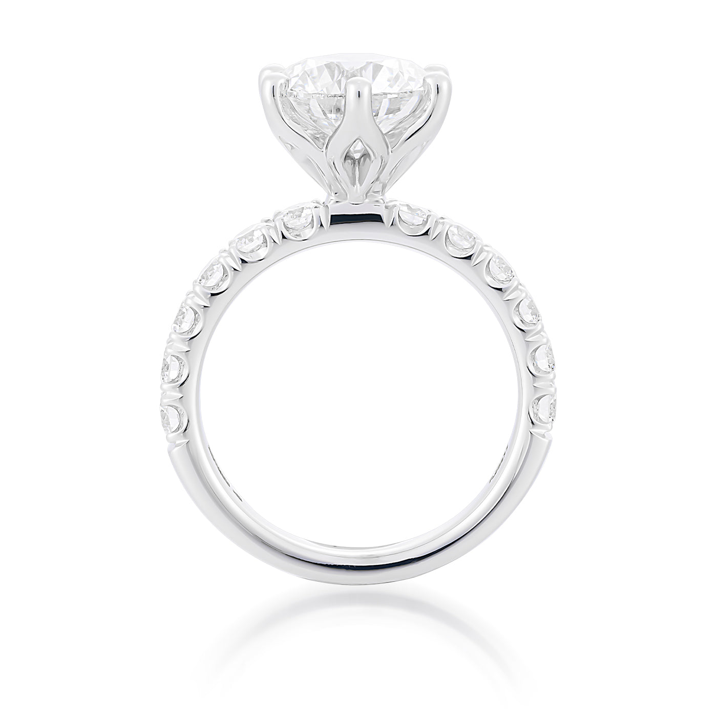 Introducing the Raffi&Co.® 14K White Gold Round Brilliant Solitaire Lab Diamond Engagement Ring by Raffi&Co: This exquisite ring showcases a prominent round diamond set in a prong setting, complemented by smaller lab diamonds adorning the band. The side view reveals the intricate design of the setting, enhancing the brilliance and sparkle of these stunning stones.