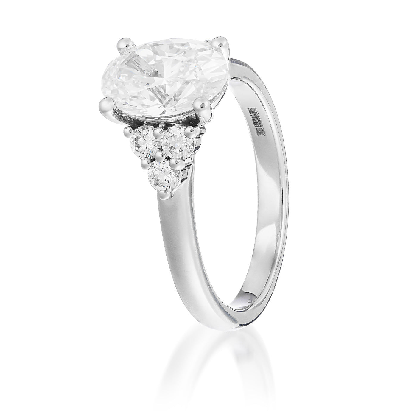 Introducing the Raffi&Co.® 14K White Gold Oval Three Stone Lab Diamond Engagement Ring: This exquisite piece features a radiant center diamond elegantly flanked by two smaller heart-shaped diamonds, all crafted from luxurious 14K white gold with a smooth, polished band—making it an exceptional choice for any memorable occasion.