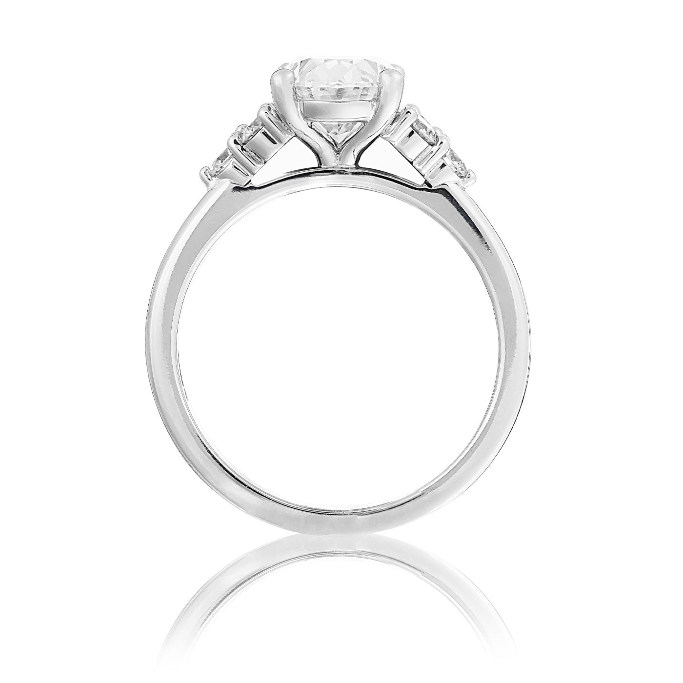 The Raffi&Co.® 14K White Gold Oval Three Stone Lab Diamond Engagement Ring features an exquisite close-up view, highlighting the center diamond flanked by smaller stones. The elegant setting and shiny finish are beautifully showcased against a plain white background, emphasizing the ring's craftsmanship.