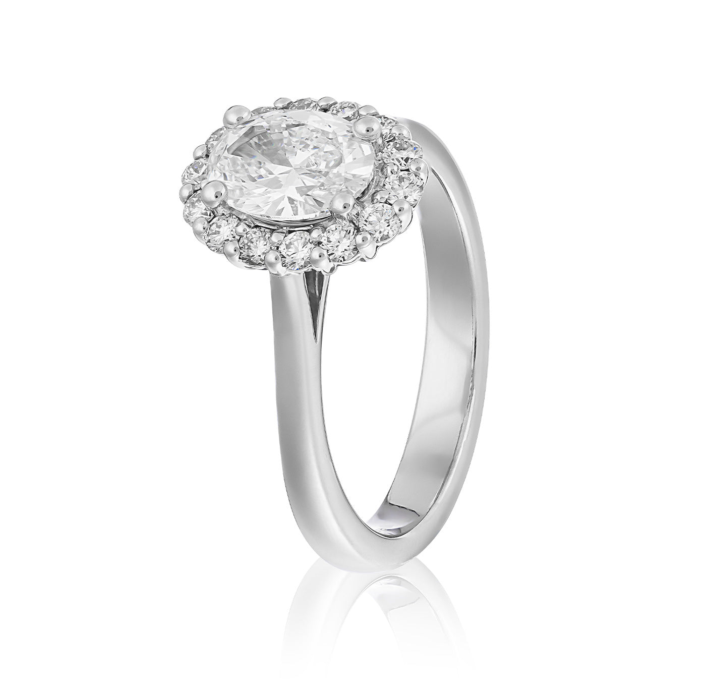 Introducing the Raffi&Co.® 14K White Gold Oval Halo Lab Diamond Engagement Ring, a breathtaking piece by Raffi&Co. This ring features an eye-catching oval diamond at its center, encircled by a halo of smaller dazzling diamonds. The sleek and reflective band amplifies the brilliance of the gems, offering an exquisite and sophisticated touch.