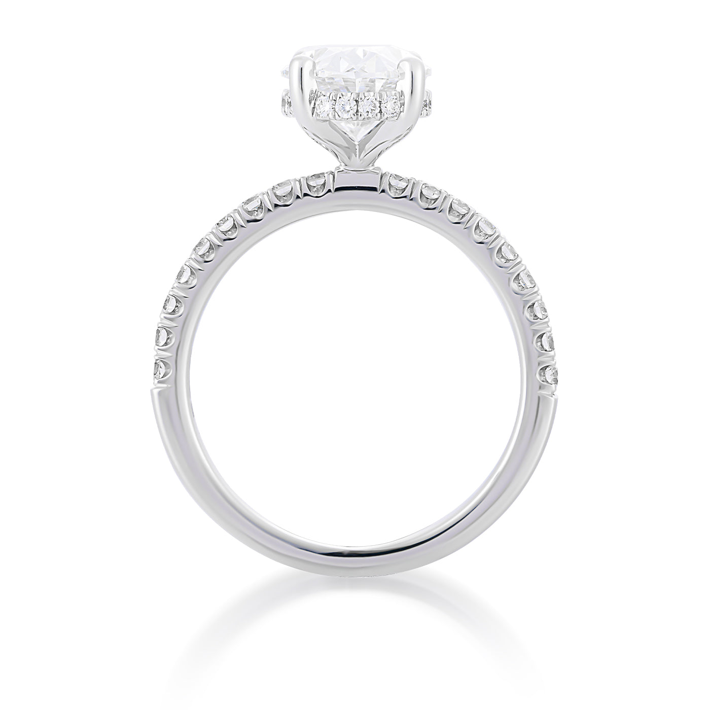 A side view of the Raffi&Co.® 14K White Gold Oval Hidden Halo Diamond Engagement Ring highlights a stunning oval lab diamond in a prong setting, surrounded by smaller diamonds along the band and a concealed halo. The ring is gracefully presented against a white background.