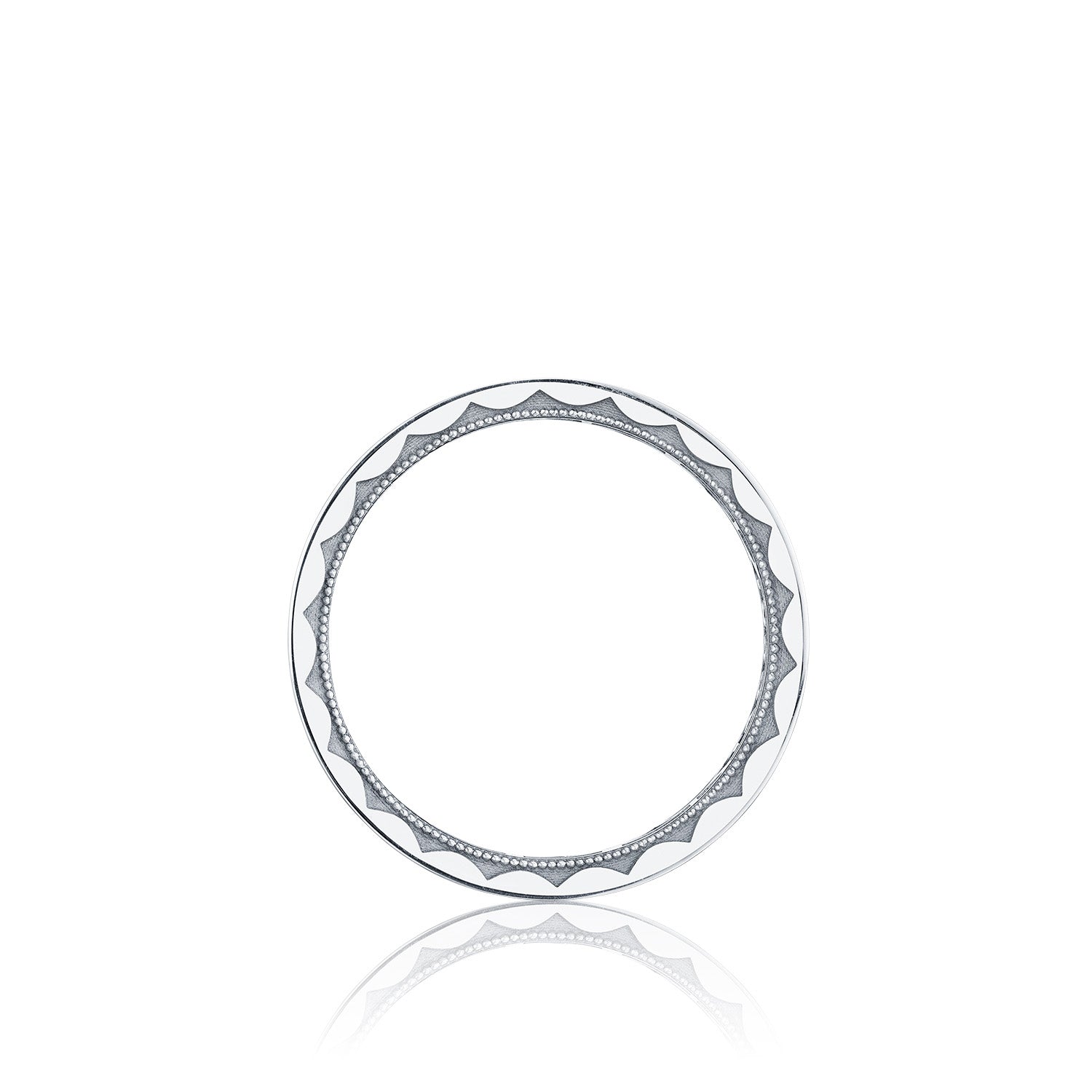 A round, white ceramic plate with a decorative black geometric pattern on the rim echoes the Tacori High Polish Finish 18K White Gold Men's Round Brilliant Diamond Wedding Band by featuring alternating wavy lines and dotted accents. The plate is centered over a white background.