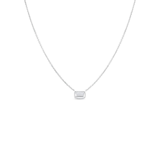 The Roberto Coin Diamonds By The Inch 18K White Gold Large Emerald Cut Diamond Necklace Pendant is a sophisticated piece from the renowned brand Roberto Coin. This delicate silver necklace showcases a prominent rectangular pendant adorned with an emerald-cut diamond, crafted in elegant 18k white gold. Placed against a simple white background, the design exudes minimalist elegance and charm.