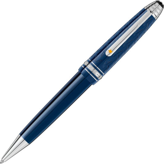 A stylish Montblanc Meisterstuck Le Petit Prince Midsize Ballpoint Pen, featuring a blue and silver design with intricate barrel detailing reminiscent of Le Petit Prince's stars, and equipped with a metallic clip, displayed on a white background.