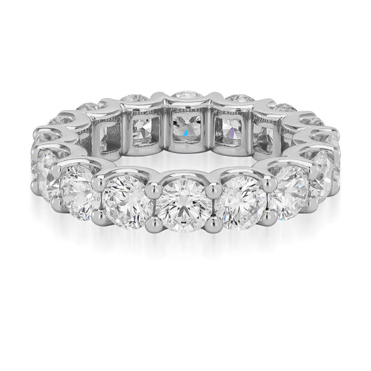 The Raffi&Co.® Signature 18K White Gold Round Brilliant Diamond Eternity Ring boasts a full circle of radiant round-cut diamonds, delicately set in individual prongs. Made from 18K white gold, these diamonds are carefully arranged to highlight their brilliance and clarity against the polished band.