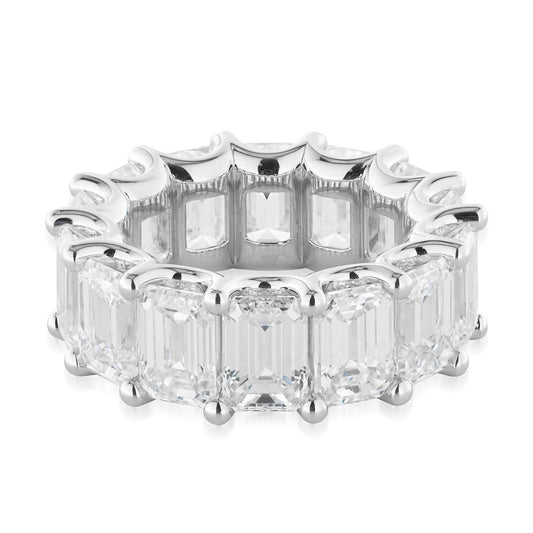 The Raffi&Co.® 14K White Gold Emerald Diamond Eternity Ring is adorned with a series of large, emerald-cut gemstones securely set in prongs to create an unbroken loop. These stones are meticulously arranged on a white gold band, embodying elegance and sophistication under the renowned craftsmanship of Raffi&Co.