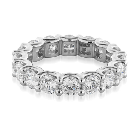 Presenting the Raffi&Co.® 14K White Gold Round Brilliant Lab Diamond Eternity Ring, an elegant anniversary ring encrusted with a continuous circle of round, sparkling lab diamonds. The inner band is adorned with engraved markings, showcasing an intricate and luxurious design by Raffi&Co.