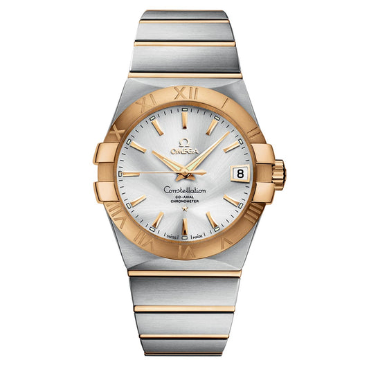 The OMEGA Constellation Co-Axial Chronometer 38mm Watch features a silver circular face, an 18K yellow gold bezel with Roman numerals, and hour markers in silver and gold. Its date display is safeguarded by a scratch-resistant sapphire crystal. The watch is complemented by an elegantly designed two-tone bracelet that alternates between silver and gold links.