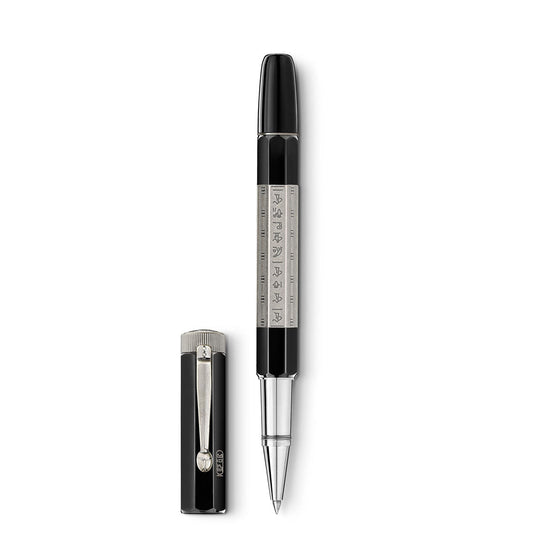 The Montblanc Heritage Egyptomania Doue Rollerball Pen, featuring a black and silver design with intricate patterns on the barrel, is paired with its matching cap that includes a metal clip. With its glossy finish, the pen radiates an elegant and sophisticated charm inspired by Egyptomania's rich artistic legacy.