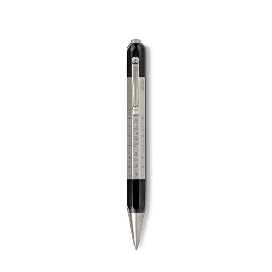 The Montblanc Heritage Egyptomanian Doue Ballpoint Pen, crafted by Montblanc, boasts a sleek black body with silver accents reminiscent of Egyptian pens. It features a built-in ruler and stylus tip, complemented by a convenient clip. Its hexagonal shape includes metric measurements and is presented vertically against a plain white backdrop.