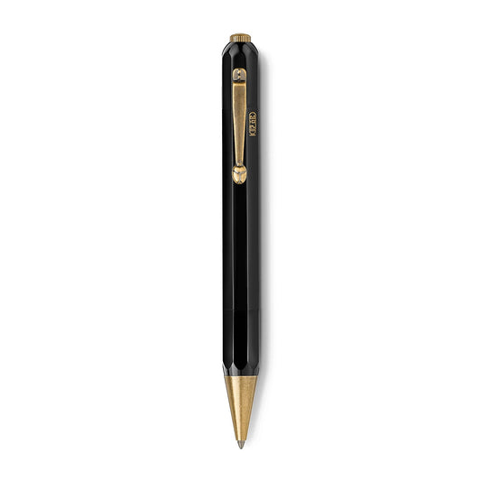 The Montblanc Heritage Egyptomanian Special Edition Black Ballpoint Pen showcases a sleek, shiny design inspired by Egyptian pens. It features an octagonal shape for enhanced aesthetic appeal, black with gold accents, and includes a side clip for fastening. The pen is finished with a pointed gold tip at the bottom.