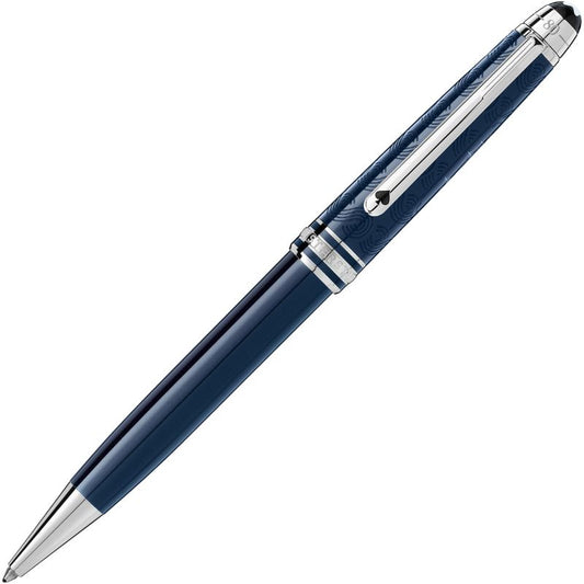 A sleek Montblanc Meisterstück Around the World in 80 Days Classique Ballpoint Pen, featuring a stylish blue design with silver accents and a clip, reminiscent of intricate patterns from a Jules Verne adventure novel. The pen is angled diagonally against a white background, highlighting its elegant and sophisticated appearance.