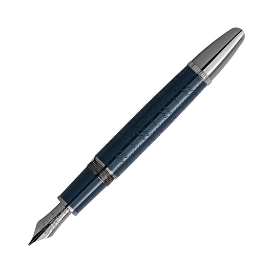 A Montblanc Writers Edition Sir Arthur Conan Doyle Limited Edition fountain pen, in dark blue with a silver nib and cap, is arranged diagonally on a white background. The barrel, showcasing an embossed pattern, adds texture to its sleek and elegant design.