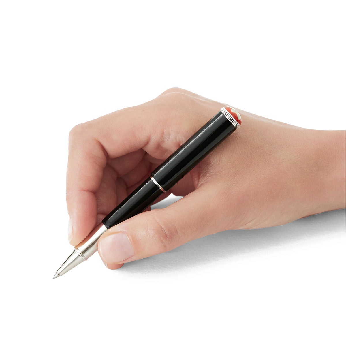 A hand holds a sleek Montblanc Heritage Rouge et Noir Baby Special Edition Black Rollerball Pen against a plain white background, showcasing the elegance and craftsmanship of the Montblanc brand.