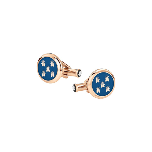 Montblanc presents their luxury cufflinks, featuring a round design with a glossy blue center embellished with white bee motifs. The stainless steel border and backing boast a gold-tone finish, exuding sophistication and elegance.