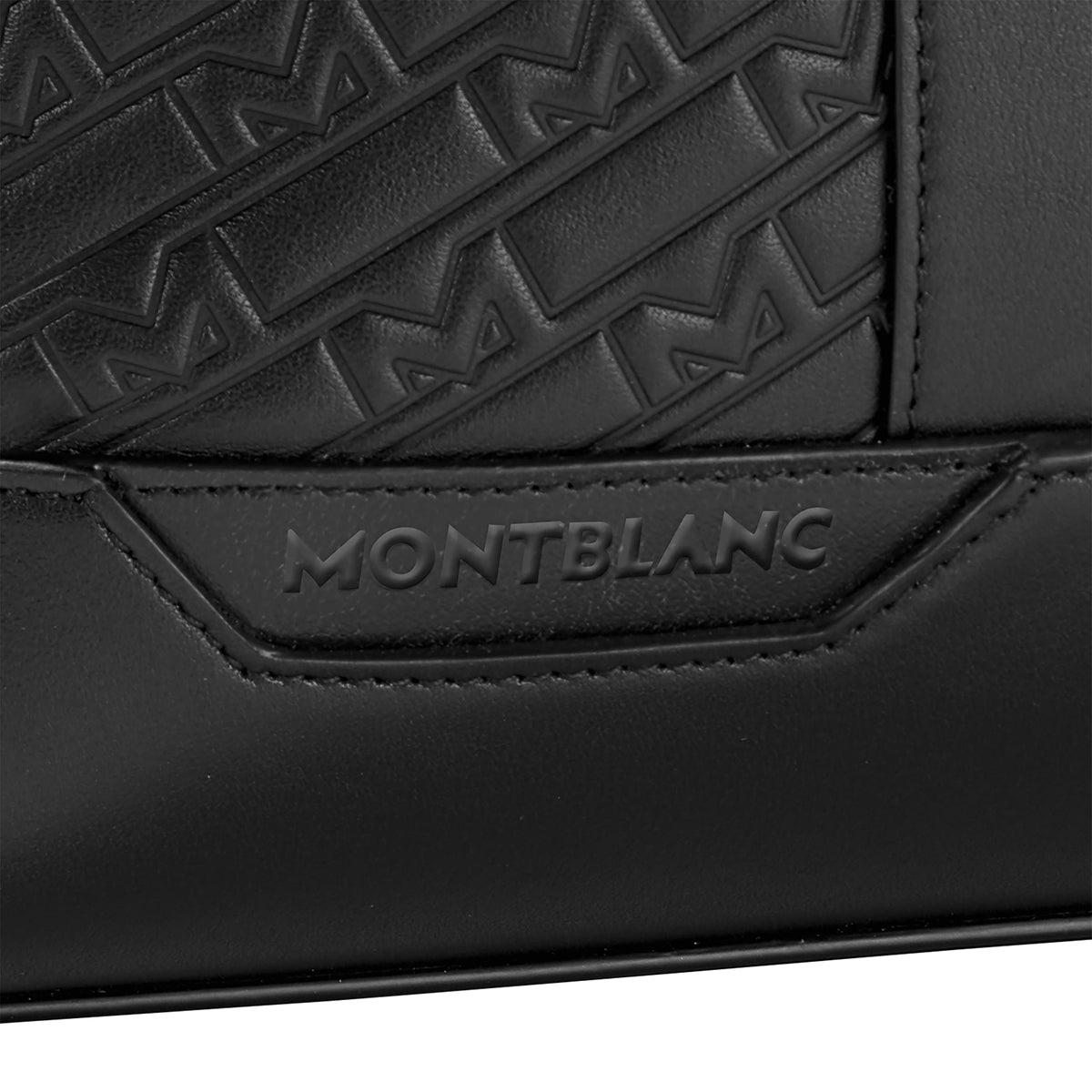Close-up of the Montblanc M Gram 4810 Slim Black Leather Document Case, adorned with embossed geometric patterns and the brand name "Montblanc" in raised letters.
