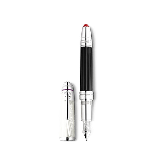 The Montblanc Great Characters Jimi Hendrix Special Edition Fountain Pen, with a sleek black grip section and silver accents, stands vertically on a white surface. The cap, adorned with a silver clip, is positioned to the left of the pen.
