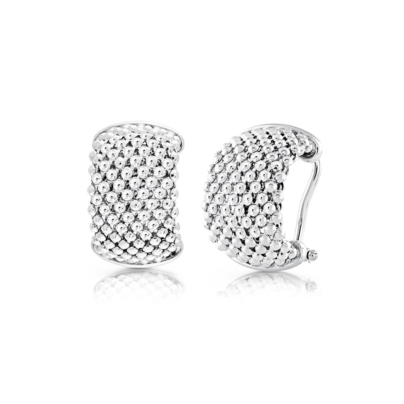 The Miss Mimi Iconic Beaded Mesh Sterling Silver Huggie Earrings by Miss Mimi by Yael are shown, highlighting their rounded shape and clasp mechanism. One earring is displayed from the front and the other from the side, emphasizing their textured design with small raised dots. Set against a plain white background, these earrings showcase their elegant simplicity.