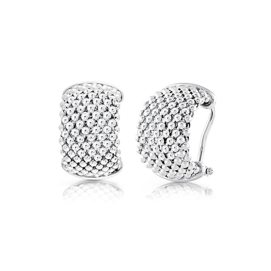 The Miss Mimi Iconic Beaded Mesh Sterling Silver Huggie Earrings by Miss Mimi by Yael are shown, highlighting their rounded shape and clasp mechanism. One earring is displayed from the front and the other from the side, emphasizing their textured design with small raised dots. Set against a plain white background, these earrings showcase their elegant simplicity.