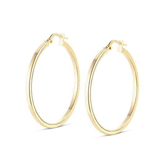 A pair of sophisticated Miss Mimi 18K Yellow Gold Vermeil and Sterling Silver Large Square Edge Hoop Earrings, showcased against a simple white backdrop. These elegant earrings from the Miss Mimi by Yael collection feature clasp closures and boast a 45mm diameter, positioned upright for a sleek appearance.