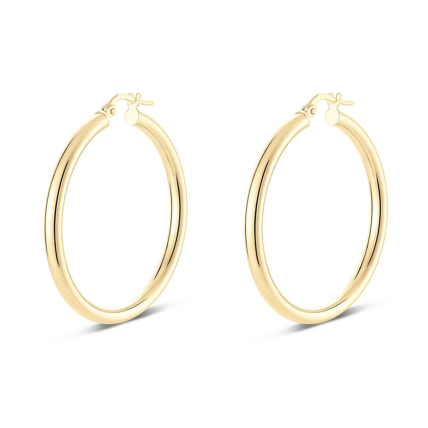 Displayed against a plain white background, the Miss Mimi 18K Yellow Gold Vermeil and Sterling Silver Medium Round Tube Hoop Earrings by Miss Mimi by Yael boast a stunning design with a smooth, reflective finish. With their 35mm diameter and hinged closures, these earrings cast subtle shadows beneath them.