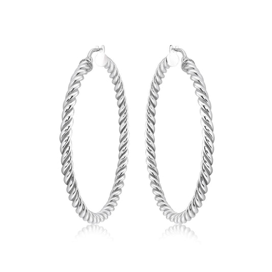 Enhance your look with the Miss Mimi Sterling Silver Small Twist Hoop Earrings by Miss Mimi by Yael. These earrings showcase a polished finish and a spiral design, embodying elegance and sophistication on a plain white background. Carefully crafted in Italy, they offer timeless beauty to complement any ensemble.