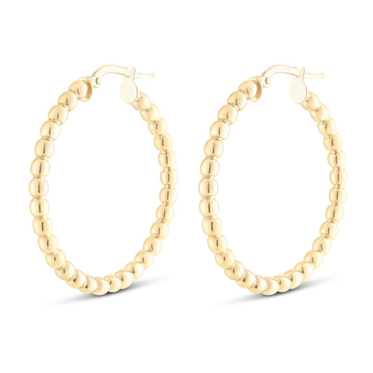 Introducing the Miss Mimi 18K Yellow Gold Vermeil and Sterling Silver Large Beaded Hoop Earrings by Miss Mimi by Yael. These elegant hoops feature a beaded design, crafted from 18kt yellow gold vermeil. The earrings showcase small, round beads arranged in a circular pattern, complete with a secure clasp at the top for fastening.