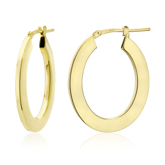 Crafted in Italy, the Miss Mimi by Yael 18K Yellow Gold Vermeil and Sterling Silver Medium Flat Oval Tube Hoop Earrings feature a smooth, polished finish and a cylindrical shape with a hinge clasp. These elegant earrings are elegantly captured against a plain white background.