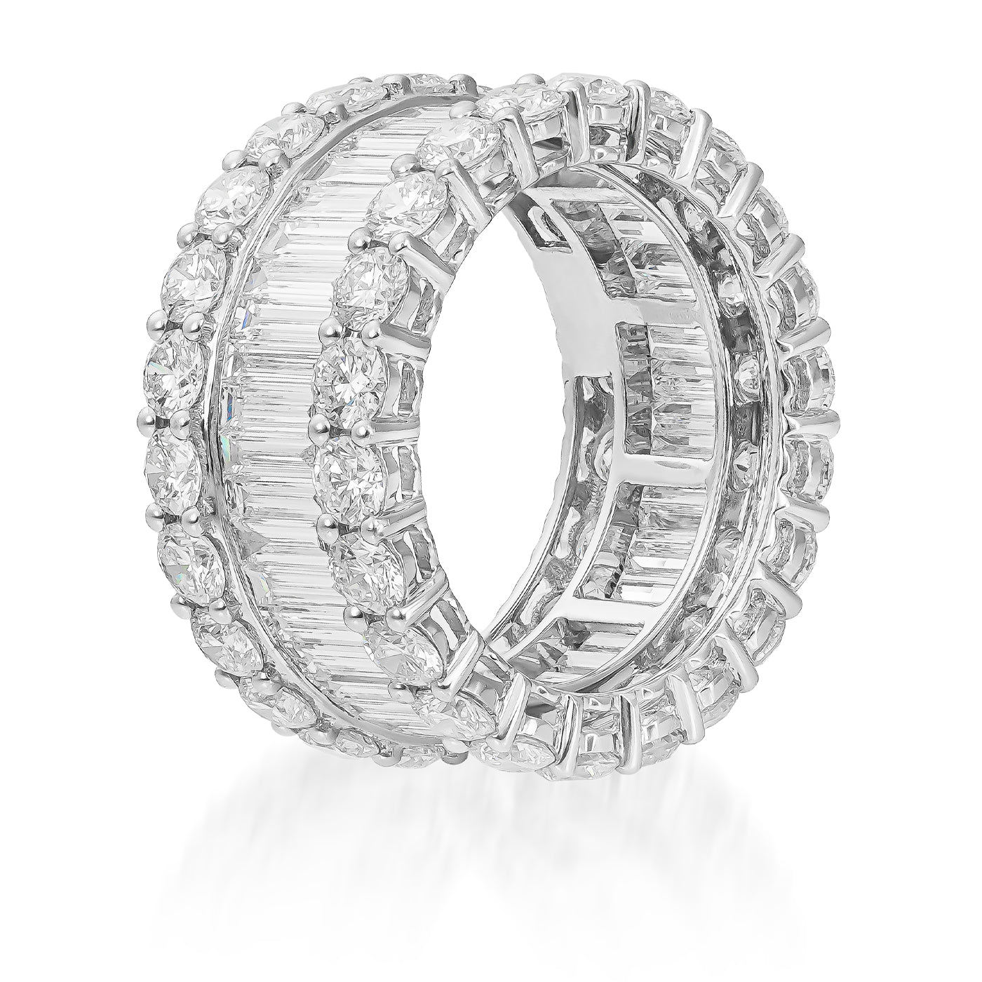 Two Raffi&Co.® 18K White Gold Fashion Rings, adorned with circular, rectangular, and baguette-cut diamonds, are elegantly stacked side by side. The exquisite craftsmanship of Raffi&Co.® features alternating rows of various diamond cuts, offering a luxurious and sparkling display against a pristine white backdrop.