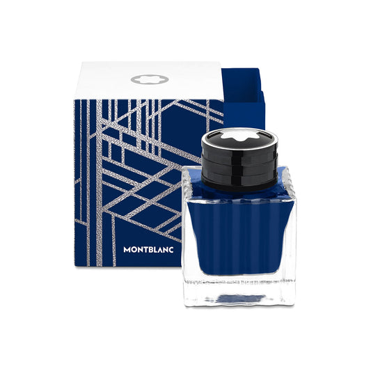 The square blue ink bottle with a sleek black cap is beautifully positioned in front of a matching blue and white box adorned with an abstract line pattern. The brand "Montblanc" is boldly displayed on the packaging, making this Montblanc Ink Bottle 50ml Blue Starwalker Space Blue an ideal collectible gift for enthusiasts.