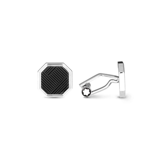 A pair of cufflinks from the Montblanc Extreme 3.0 Collection features an octagonal silver design with intricate black engraved patterns. One cufflink is displayed upright, highlighting the face design, while the other reveals the side view, showcasing its meticulous fastening mechanism.
