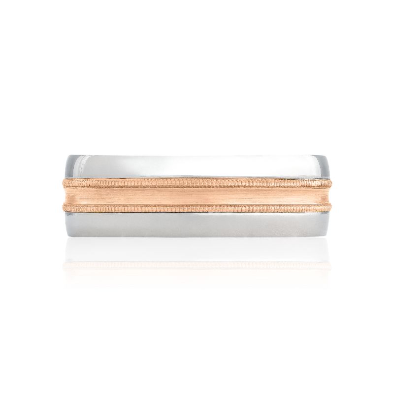 A Tacori Classic Two-Tone Finish 18K White and Rose Gold Classic Wedding Band is elegantly displayed on a white surface, catching the light. The contemporary and refined design, highlighted by its contrasting colors, underscores the dual-metal craftsmanship.